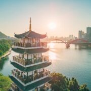 Setting sun shines on a tower by the river in Liuzhou, Guangxi, China, Asia